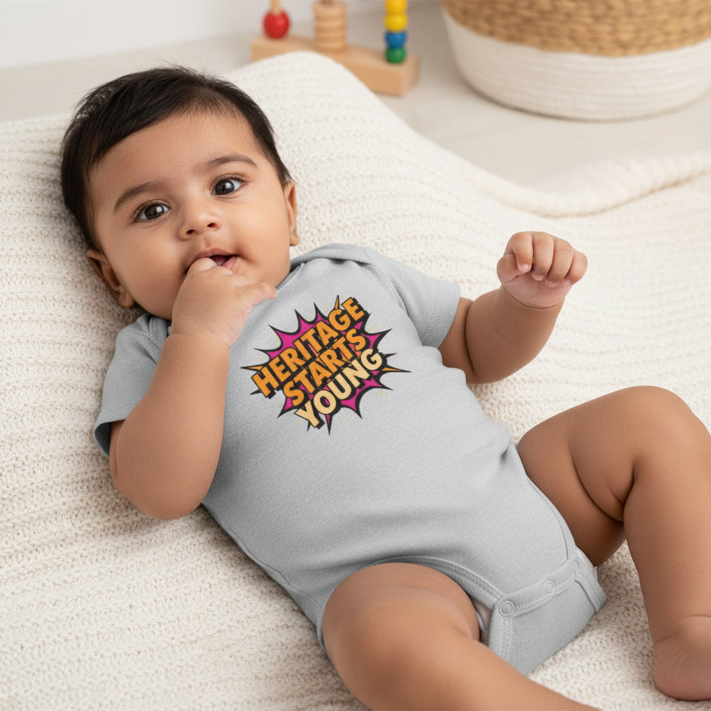 Gray baby onesie with 'Heritage Starts Young' text on a white background
